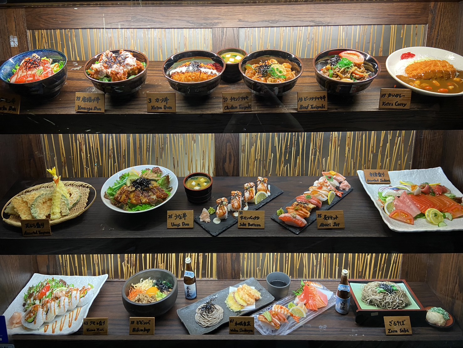 Sushi and donburi food replica window display drawing foot traffic at a Japanese restaurant storefront