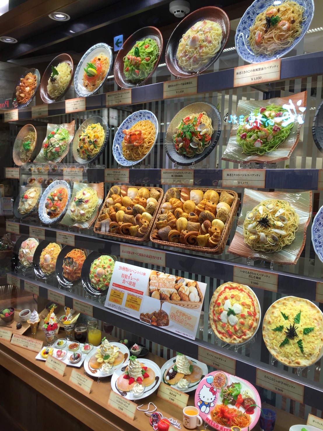 A full wall of noodle and rice dish food replicas showing an entire Chinese restaurant menu