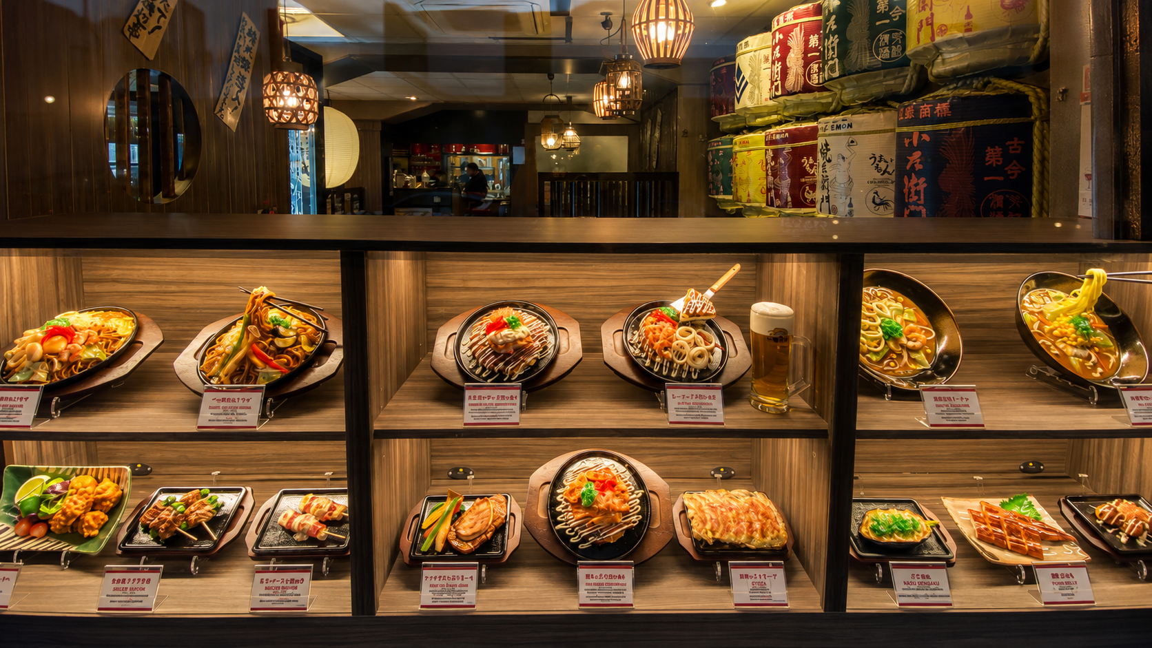 Two shelves of genuine Japanese food replicas in an izakaya window, including okonomiyaki, yakisoba, gyoza and beer