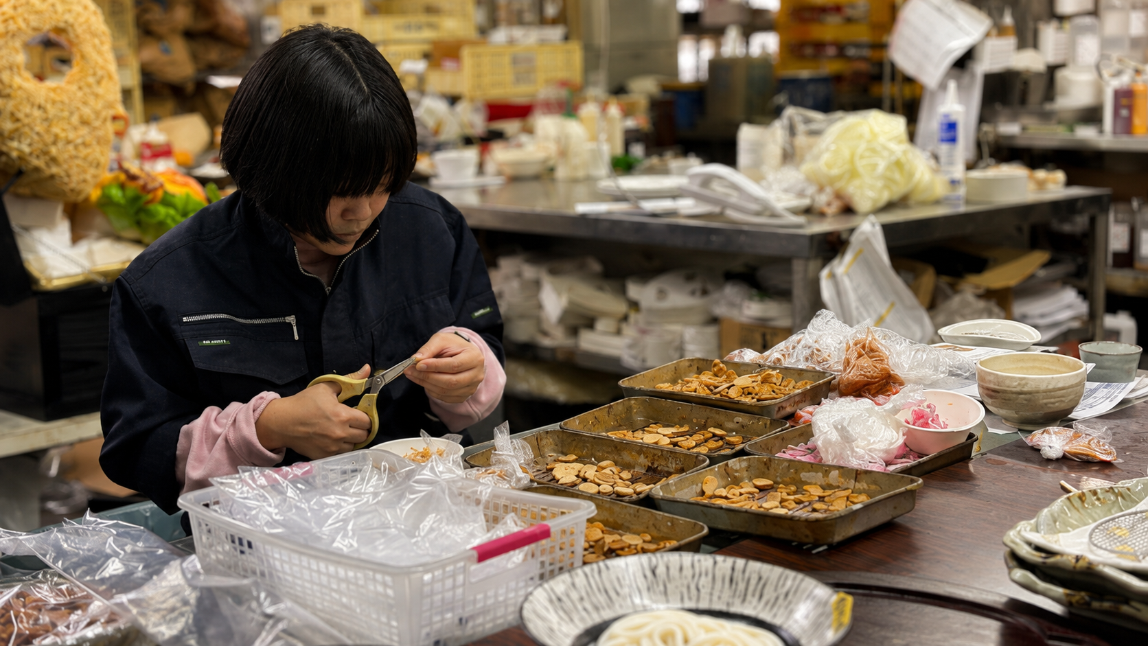 A craftsperson handcrafting food replicas in a Japanese workshop